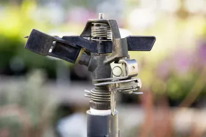 Close-up of a metal sprinkler head used for lawn irrigation repair in Sanford, Florida.